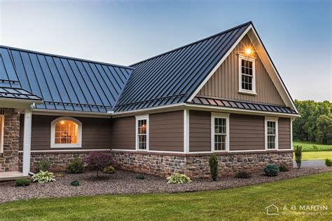 gray house with black metal roof|gray homes with black roofs.